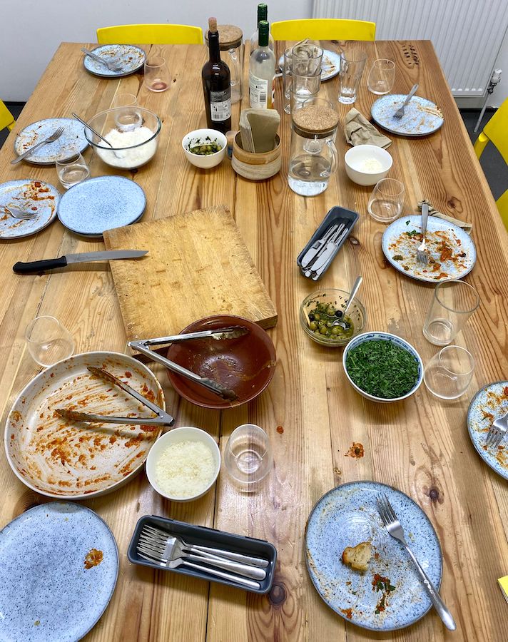 A dining table with empty plates and glasses after a satisfying meal.