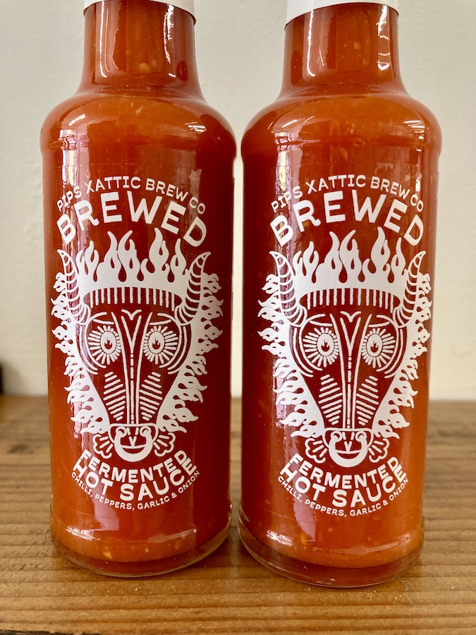 Two bottles of Pip's Brewed hot sauce