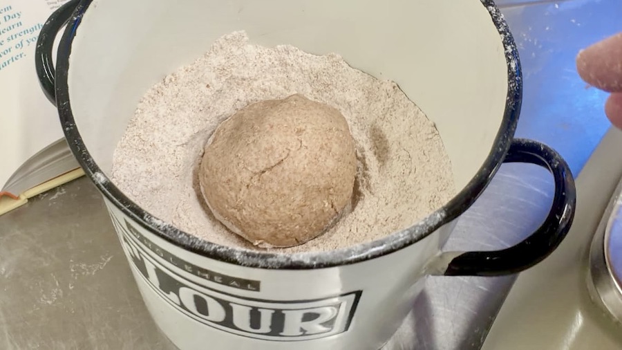 Desen sourdough ball in a tub of flour